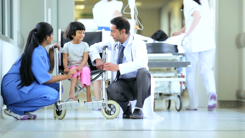 Pediatrician And Nursing Aide Cheering Up Indian Girl In Wheelchair ...