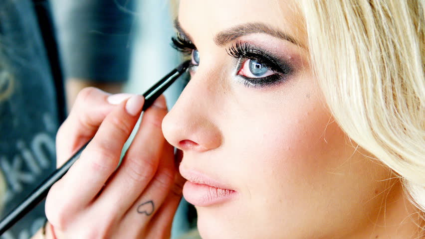 Beautician Applying Cosmetics On A Young Model HooDoo Wallpaper