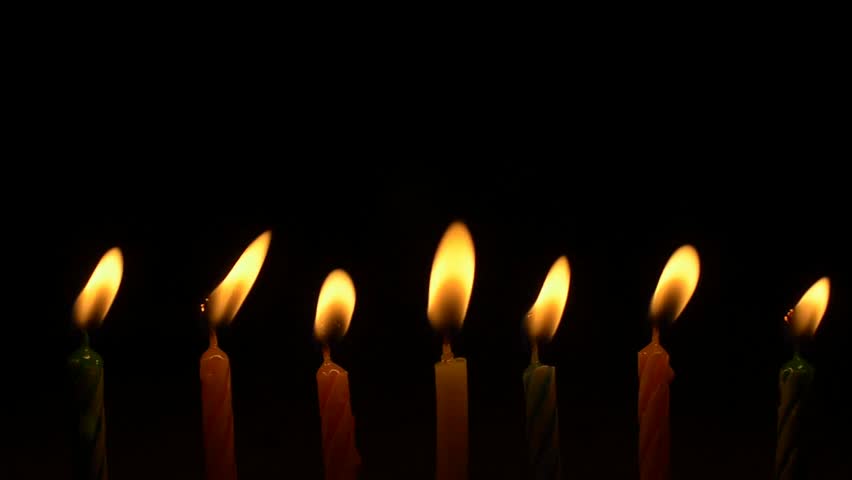Footage Colorful Burning Candles Set On Black Background. 4k Video