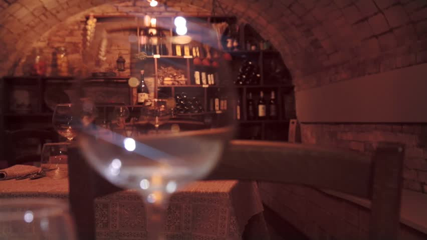 Fancy Restaurant Background tracking shot of red glass wine. on the background, wooden table Fancy Restaurant Background tracking shot of red glass wine. on the background, wooden table