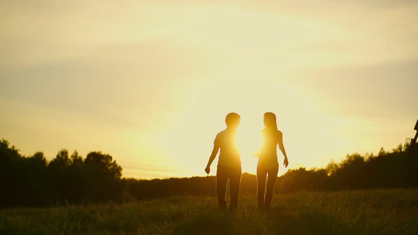 Happy Young Couple Walking On Summer Field Holding Hands, Outdoors ...